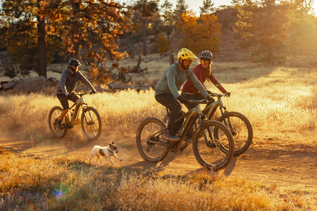 Three people riding their Aventon Ramblas Ebikes on a trail